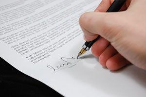 person signing a contract