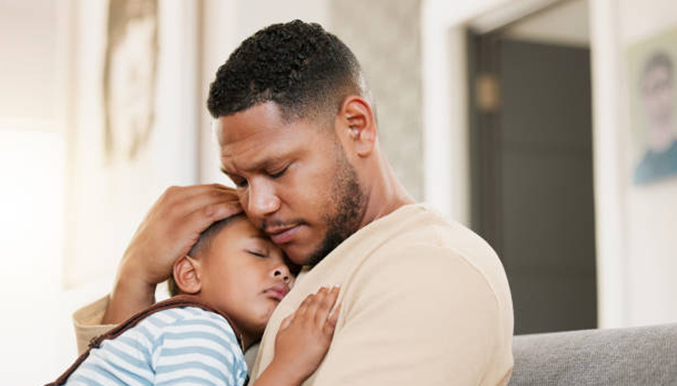 man holding a sleeping child