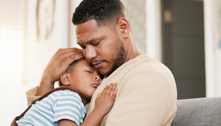 man holding a sleeping child