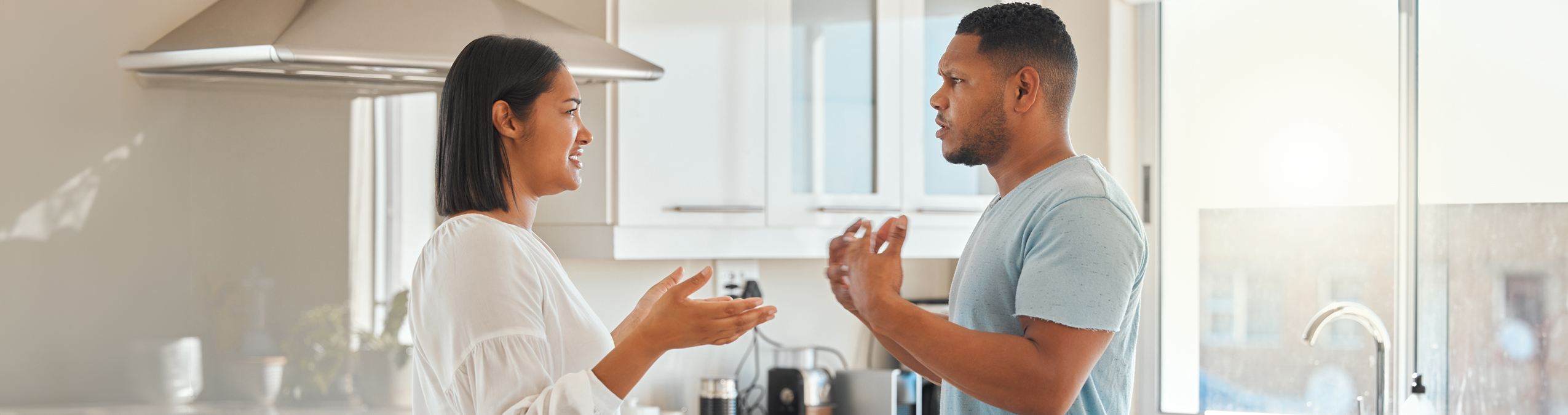 Two people arguing in a kitchen