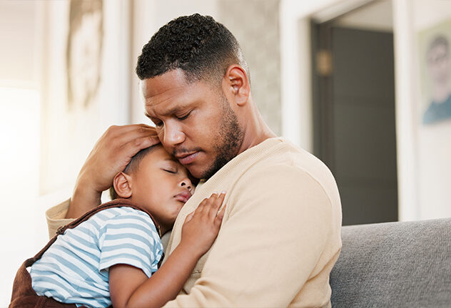 Dad holding a sleeping child