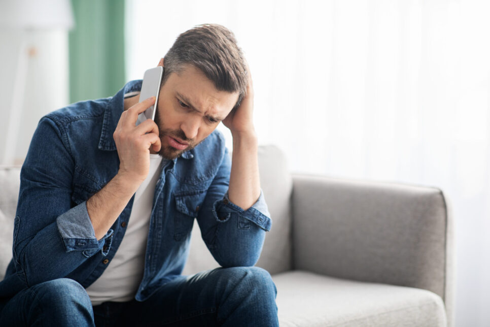 concerned man talking on the phone