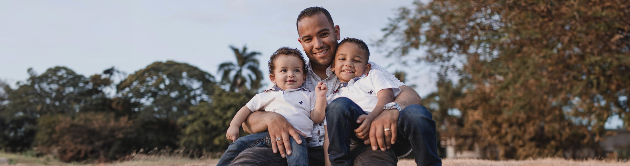 Man with two young children sitting in his lap