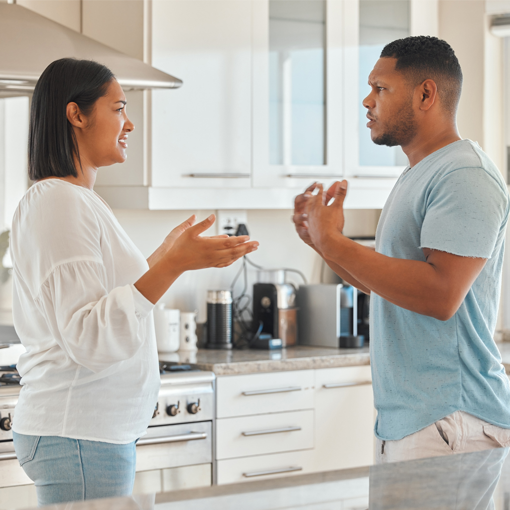 A couple arguing in a kitchen