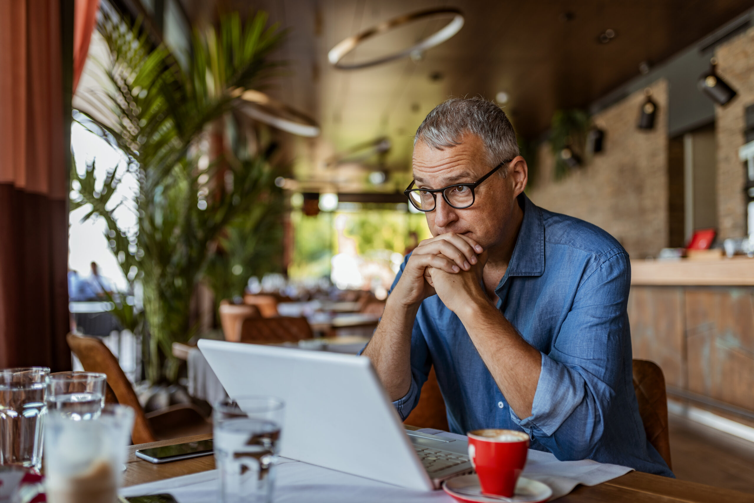 Stressed man looking at computer